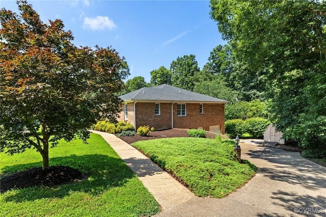 4410 Sharonridge Dr, North Chesterfield, VA 23236 - view of front of home featuring driveway, brick siding, a front yard, an attached garage, and a storage shed
