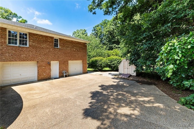 4410 Sharonridge Dr, North Chesterfield, VA 23236 - view of home's exterior with brick siding, concrete driveway, a storage unit, and an attached garage