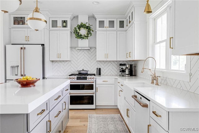 3013 Swanns Inn Cres, Goochland, VA 23063 - kitchen featuring white appliances, light countertops, pendant lighting, tasteful backsplash, and light wood-style floors