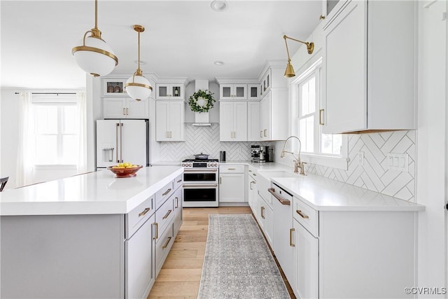 3013 Swanns Inn Cres, Goochland, VA 23063 - kitchen featuring white appliances, light countertops, hanging light fixtures, a center island, and recessed lighting