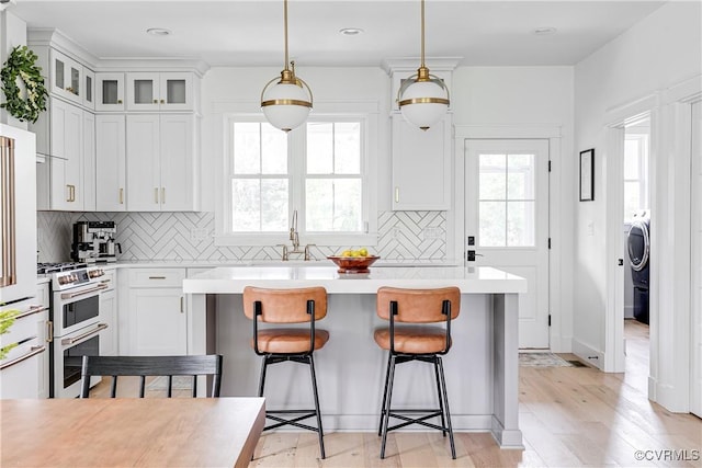 3013 Swanns Inn Cres, Goochland, VA 23063 - kitchen featuring range with two ovens, light countertops, plenty of natural light, a center island, and recessed lighting