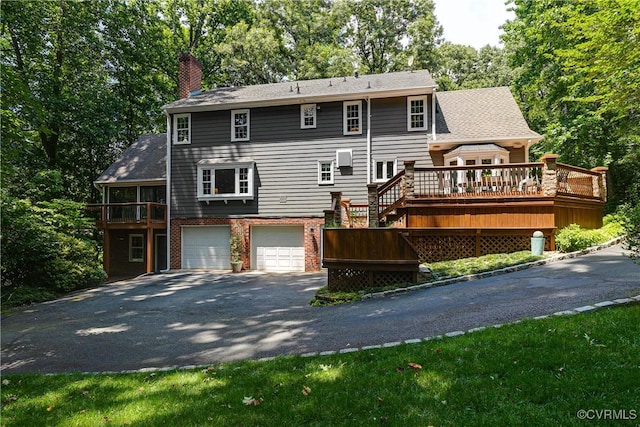 12103 Wexwood Pl, North Chesterfield, VA 23236 - back of property featuring driveway, an attached garage, a chimney, a wooden deck, and stairs