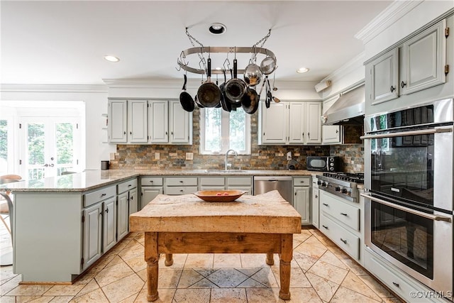 12103 Wexwood Pl, North Chesterfield, VA 23236 - kitchen featuring appliances with stainless steel finishes, a peninsula, ventilation hood, gray cabinetry, and healthy amount of natural light