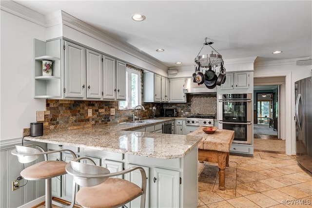 12103 Wexwood Pl, North Chesterfield, VA 23236 - kitchen featuring stainless steel appliances, a peninsula, gray cabinets, backsplash, and light stone countertops