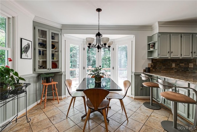 12103 Wexwood Pl, North Chesterfield, VA 23236 - dining space with a chandelier, healthy amount of natural light, stone tile flooring, crown molding, and a decorative wall