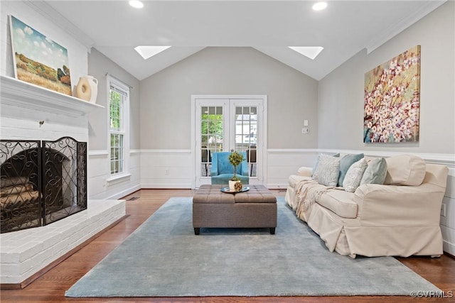 2801 Aspinwald Dr, Henrico, VA 23233 - living area featuring a skylight, a wainscoted wall, lofted ceiling, wood finished floors, and a brick fireplace