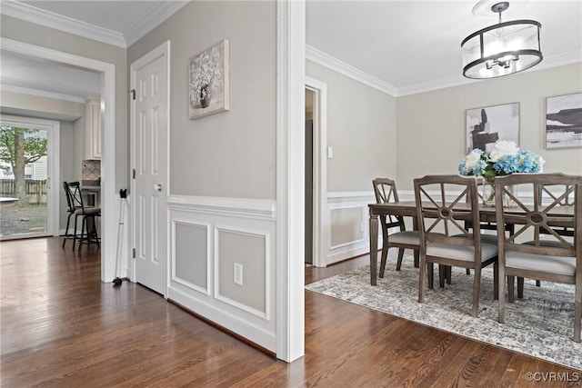 2801 Aspinwald Dr, Henrico, VA 23233 - dining room with dark wood-type flooring, crown molding, a chandelier, and a wainscoted wall