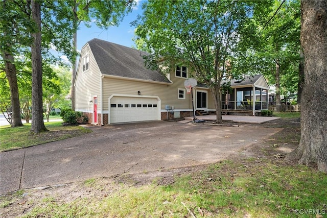 2801 Aspinwald Dr, Henrico, VA 23233 - view of front of home with driveway, a sunroom, an attached garage, and roof with shingles
