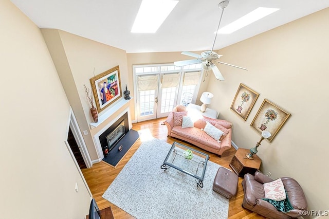 302 Myrtle St Unit F, Ashland, VA 23005 - living area featuring a skylight, wood finished floors, ceiling fan, and high vaulted ceiling