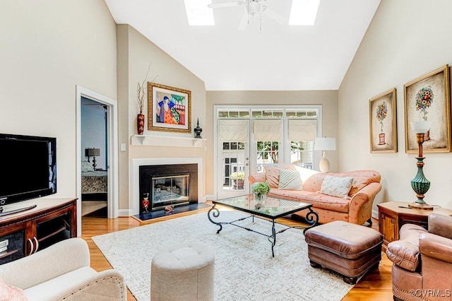 302 Myrtle St Unit F, Ashland, VA 23005 - living room featuring a ceiling fan, a skylight, wood finished floors, high vaulted ceiling, and a glass covered fireplace
