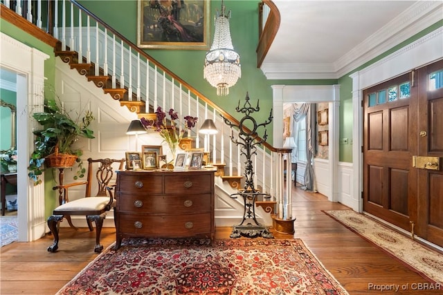 985 Kingston Ln, North, VA 23128 - entrance foyer featuring a decorative wall, hardwood / wood-style flooring, stairway, a chandelier, and crown molding