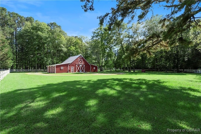 985 Kingston Ln, North, VA 23128 - view of yard with a barn, an outdoor structure, and a wooded view