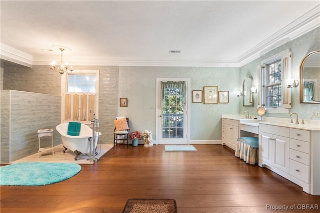 985 Kingston Ln, North, VA 23128 - bathroom featuring a chandelier, vanity, a soaking tub, crown molding, and hardwood / wood-style floors