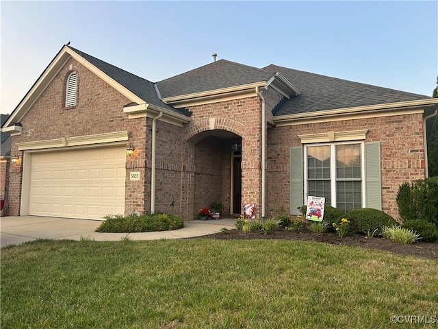 5623 Virginia Park Dr, Providence Forge, VA 23140 - view of front of property featuring brick siding, a shingled roof, a front yard, driveway, and an attached garage
