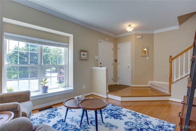 8750 Springwater Dr, Henrico, VA 23228 - living area with wood finished floors, stairway, and crown molding