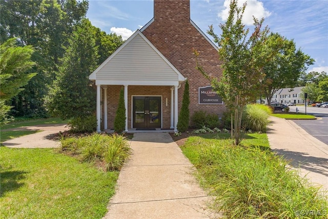 8750 Springwater Dr, Henrico, VA 23228 - view of front of property featuring brick siding, french doors, and a chimney