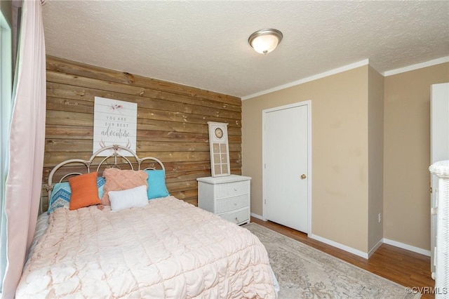 3737 Shelton Store Rd, Buckingham, VA 23921 - bedroom featuring wood finished floors, crown molding, wood walls, and a textured ceiling