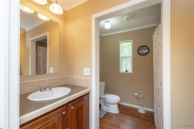 3737 Shelton Store Rd, Buckingham, VA 23921 - bathroom featuring vanity, crown molding, wood finished floors, and backsplash