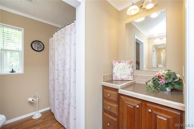 3737 Shelton Store Rd, Buckingham, VA 23921 - full bathroom featuring wood finished floors, vanity, ornamental molding, a shower with curtain, and a textured ceiling