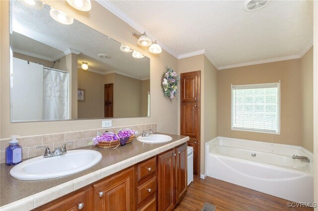 3737 Shelton Store Rd, Buckingham, VA 23921 - bathroom featuring wood finished floors, double vanity, a bath, and crown molding
