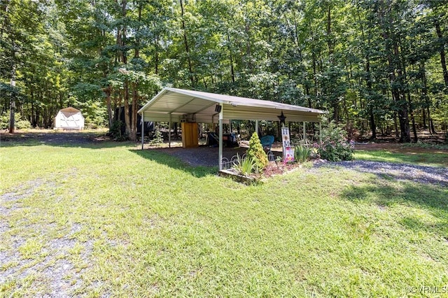 3737 Shelton Store Rd, Buckingham, VA 23921 - view of grassy yard featuring a detached carport and a storage unit