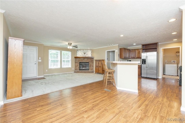 3737 Shelton Store Rd, Buckingham, VA 23921 - kitchen with stainless steel refrigerator with ice dispenser, washer / dryer, ceiling fan, light wood-style flooring, and ornamental molding