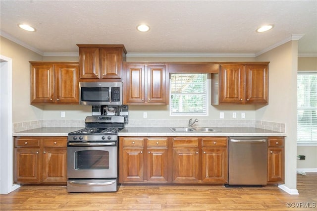 3737 Shelton Store Rd, Buckingham, VA 23921 - kitchen featuring appliances with stainless steel finishes, ornamental molding, brown cabinetry, light countertops, and recessed lighting
