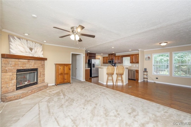 3737 Shelton Store Rd, Buckingham, VA 23921 - unfurnished living room featuring a ceiling fan, light carpet, ornamental molding, recessed lighting, and a fireplace