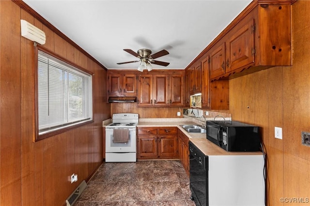 5425 Germain Rd, Richmond, VA 23224 - kitchen with black appliances, brown cabinets, light countertops, wooden walls, and ceiling fan