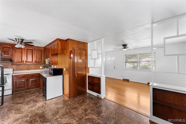 5425 Germain Rd, Richmond, VA 23224 - kitchen with a ceiling fan, white electric range, light countertops, brown cabinets, and black microwave