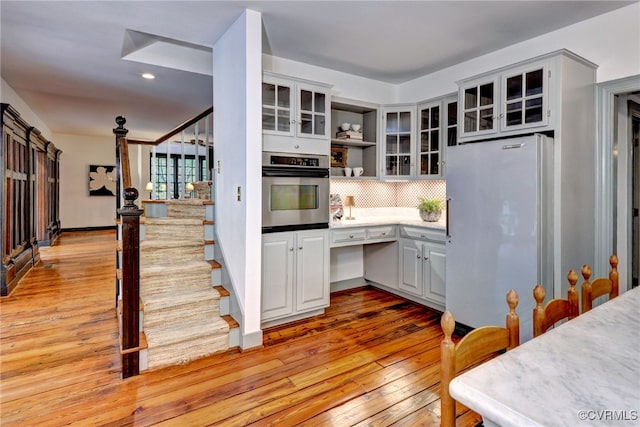 99 Walnut Hills Dr, Williamsburg, VA 23185 - kitchen featuring freestanding refrigerator, oven, light wood finished floors, open shelves, and decorative backsplash