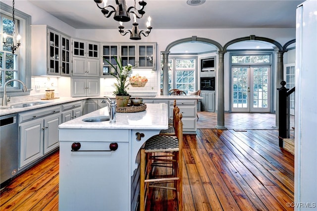 99 Walnut Hills Dr, Williamsburg, VA 23185 - kitchen featuring gray cabinets, dishwasher, a kitchen island with sink, a chandelier, and tasteful backsplash