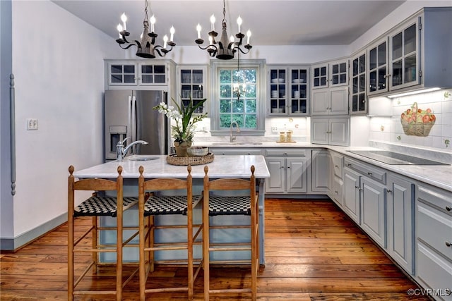99 Walnut Hills Dr, Williamsburg, VA 23185 - kitchen with stainless steel fridge, black electric cooktop, a chandelier, and dark wood-type flooring