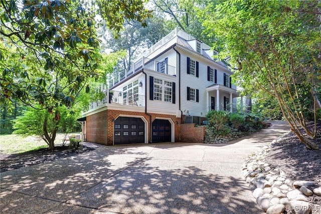 99 Walnut Hills Dr, Williamsburg, VA 23185 - view of front of home featuring a balcony, concrete driveway, an attached garage, and brick siding