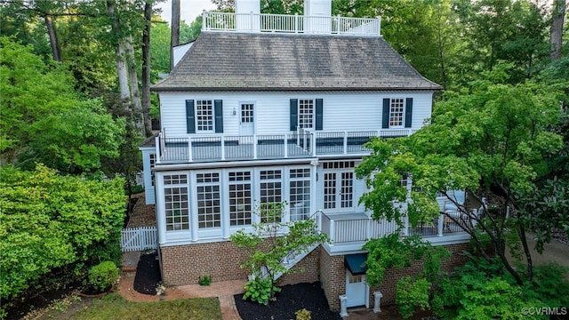 99 Walnut Hills Dr, Williamsburg, VA 23185 - back of house with a balcony, a sunroom, a shingled roof, and brick siding