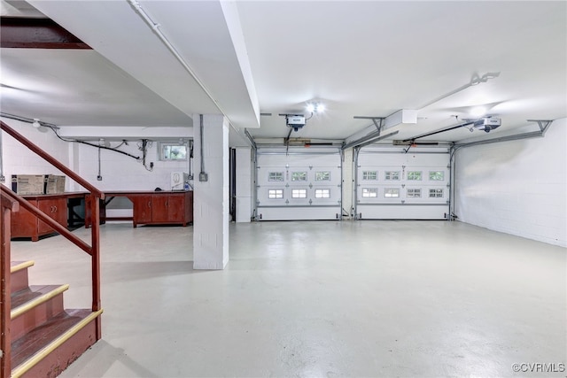 99 Walnut Hills Dr, Williamsburg, VA 23185 - garage featuring a garage door opener and concrete block wall