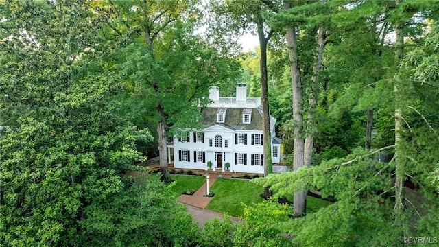 99 Walnut Hills Dr, Williamsburg, VA 23185 - back of property featuring a chimney, a yard, and a view of trees