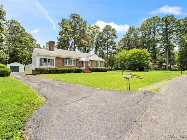 5913 Ridge Rd, Henrico, VA 23227 - view of front facade featuring an outbuilding, asphalt driveway, a chimney, brick siding, and a front lawn
