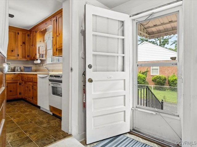 5913 Ridge Rd, Henrico, VA 23227 - kitchen featuring range, light countertops, brown cabinets, and white dishwasher