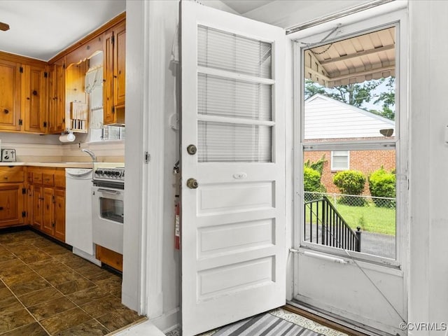 5913 Ridge Rd, Henrico, VA 23227 - kitchen featuring stove, light countertops, dishwasher, and brown cabinets