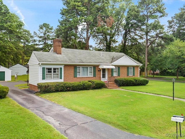 5913 Ridge Rd, Henrico, VA 23227 - view of front of home featuring brick siding, a chimney, a front yard, and driveway