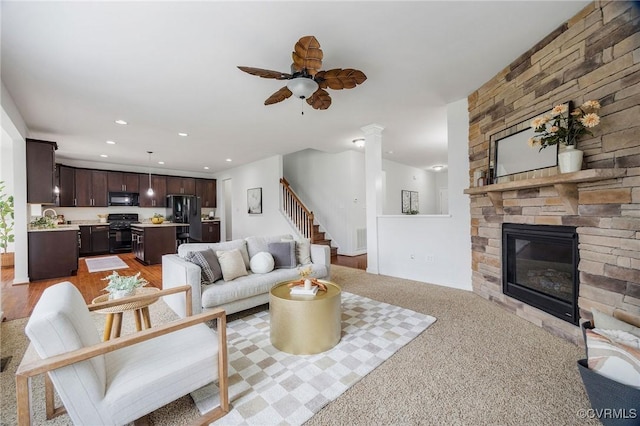 8838 Rushbrooke Ln, Mechanicsville, VA 23116 - living area with stairway, a stone fireplace, ceiling fan, recessed lighting, and decorative columns