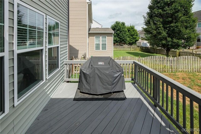 8838 Rushbrooke Ln, Mechanicsville, VA 23116 - wooden deck with area for grilling and a fenced backyard