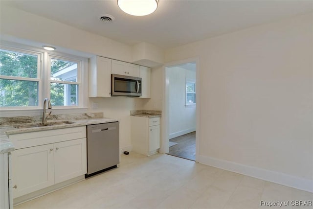727 Teach St, Hampton, VA 23661 - kitchen featuring appliances with stainless steel finishes, light stone counters, and white cabinets