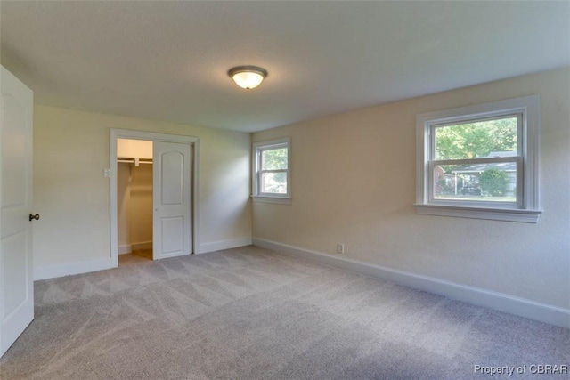 727 Teach St, Hampton, VA 23661 - unfurnished bedroom with light carpet, a walk in closet, and a closet