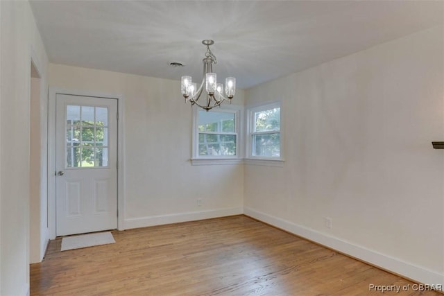 727 Teach St, Hampton, VA 23661 - unfurnished dining area with healthy amount of natural light, a chandelier, and light wood-style flooring