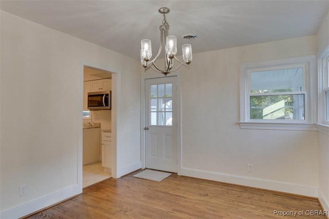 727 Teach St, Hampton, VA 23661 - doorway featuring a chandelier, light wood-style flooring, and healthy amount of natural light
