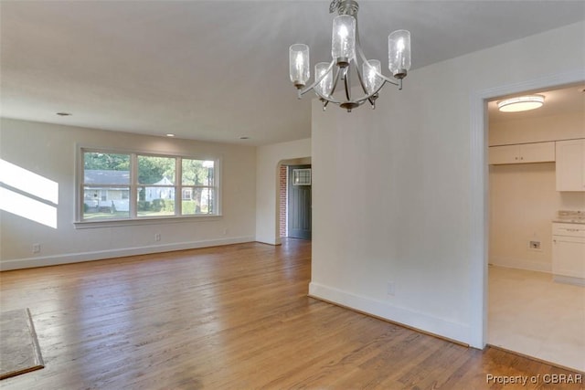 727 Teach St, Hampton, VA 23661 - unfurnished room featuring light wood finished floors and a chandelier