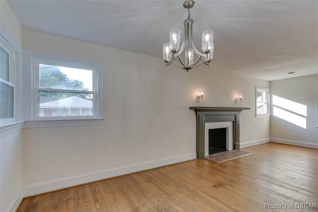 727 Teach St, Hampton, VA 23661 - unfurnished living room featuring wood finished floors, a chandelier, and a fireplace