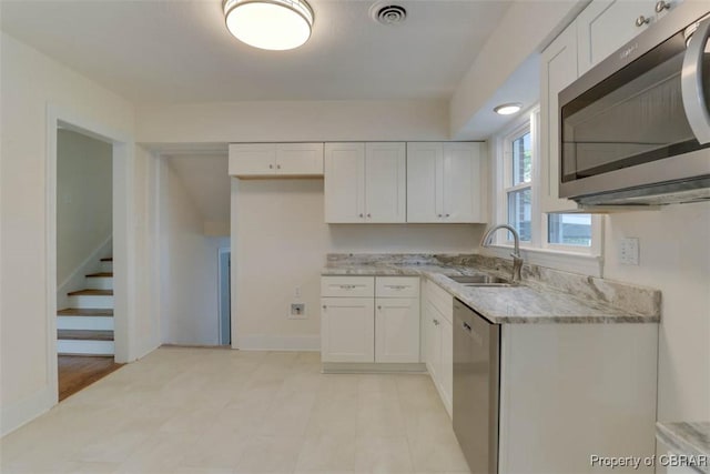 727 Teach St, Hampton, VA 23661 - kitchen featuring stainless steel appliances, white cabinetry, and light stone counters